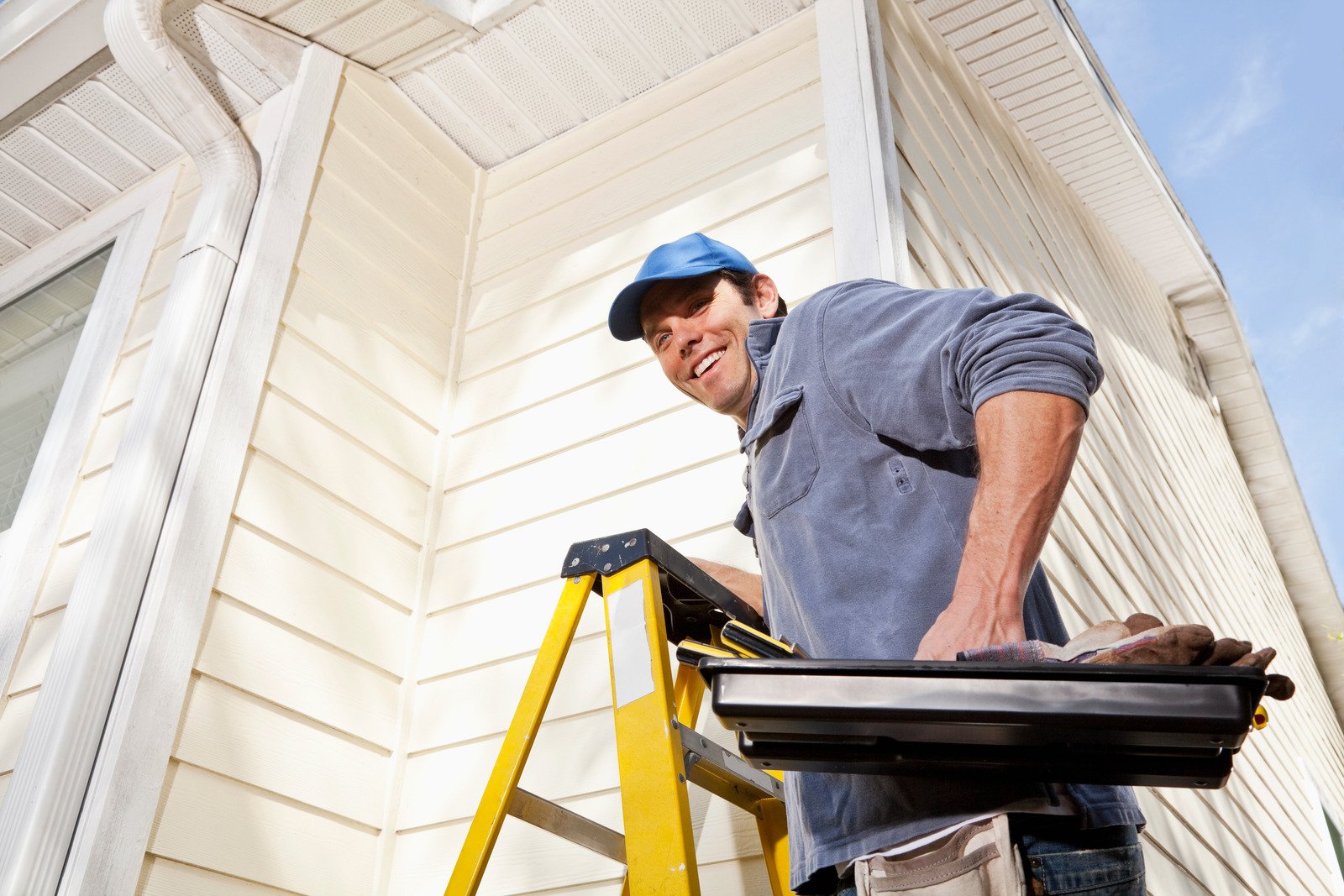 exterior contractor on a ladder